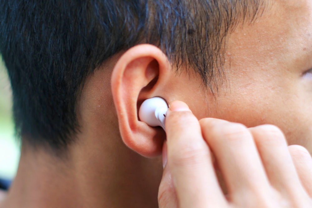 Person wearing ear buds.